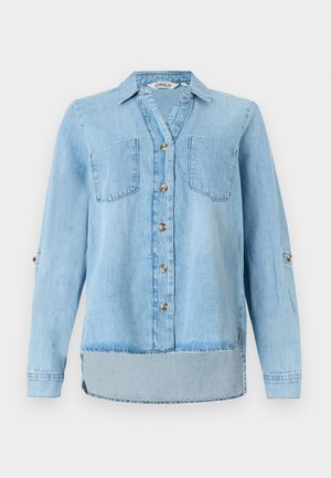 Gai zils džinsu krekls ar garām piedurknēm, pilna priekšējā pogu aizdare, divas krūšu kabatas un nedaudz izliekta apakšmalā.