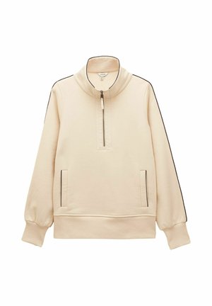 Béžový pulóver so štvrťový zip, stojacím golierom, bočnými vreckami a čiernym lemovaním pozdĺž rukávov a okrajov vreciek.