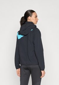 Black hooded jacket with blue accents, lightweight fabric, elastic cuffs, and a fitted design, featuring a smooth texture and minimalistic style.