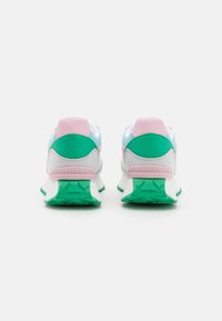 Sporty sneakers in white, pink, and green. Mesh and synthetic materials, padded heel, prominent logo on the back, textured outsole for grip.