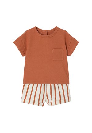 Short-sleeve rust orange toddler shirt with chest pocket paired with white shorts featuring vertical rust stripes and rolled hems.