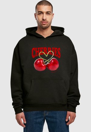 Black hoodie featuring a graphic of two red cherries intertwined with a green stem, and the word "CHERRIES" in bold red text above.