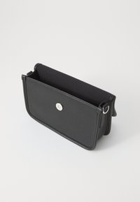 Black leather bag with a textured surface, a silver snap closure, and a smooth inner lining. Features a rectangular shape and side rings.