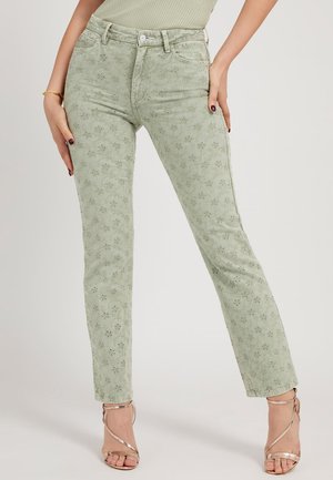 Jeans verde chiaro con ricami floreali, taglio slim, vita alta e cinque tasche. Abbinati a tacchi metallici con cinturini.