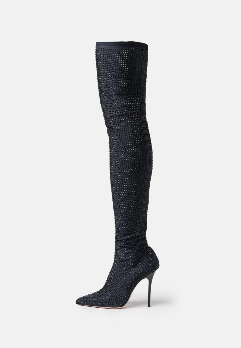 Knee-high stiletto boot in black with a textured fabric featuring small sparkles, pointed toe, and slim high heel.
