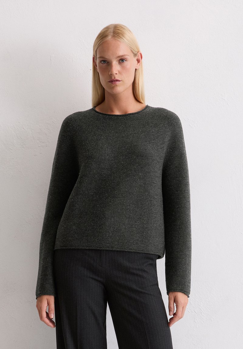 Dunkelgrauer Strickpullover mit langen Ärmeln, rundem Ausschnitt und lässiger Passform. Glatte Textur und subtile Variationen im Garn.