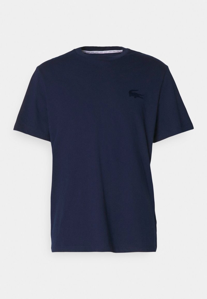 T-shirt in cotone blu navy a maniche corte con scollatura rotonda e un logo tonale sul petto. Texture liscia, vestibilità standard.