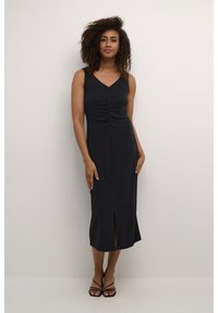 Black, sleeveless midi dress with a V-neck, gathered detailing at the bust, and a front slit for ease of movement. Smooth, stretchy fabric.