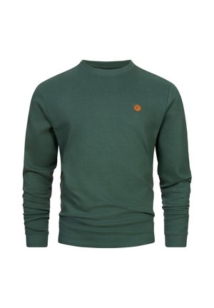 Sweatshirt vert à côtes avec des manches longues, un col rond et un petit patch en cuir sur la poitrine. Texture douce, design décontracté.