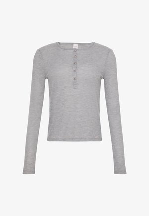 Szara bluzka z długim rękawem wykonana z prążkowanej tkaniny, z okrągłym dekoltem i czterema guzikami z przodu. Miękka w dotyku i dopasowany fason.