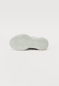 Shoe sole, rubber material, white with textured herringbone pattern, rounded edges, and curved design for enhanced grip and flexibility.