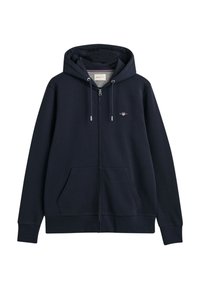 Navy zip-up hoodie with a drawstring hood, front pockets, ribbed cuffs and hem, featuring a small embroidered logo on the chest.