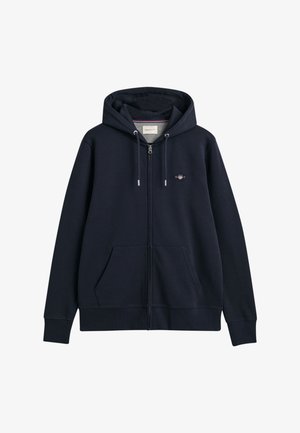 Marineblauer Zip-Hoodie mit Kordelzugkapuze, Fronttaschen, gerippten Bündchen und Saum, featuring ein kleines gesticktes Logo auf der Brust.
