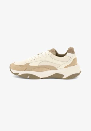 White and beige low-top sneaker with mesh and suede panels, thick sole, and white laces, shown from the side on a white background.