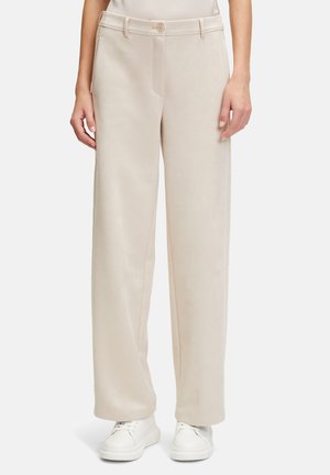 Wide-leg beige pants made of soft fabric, featuring a front button closure, side pockets, and smooth texture. Pairing with white sneakers.