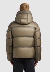 Olive green puffer jacket with a high collar, quilted design, and shiny finish. Features a logo patch on the lower left side.