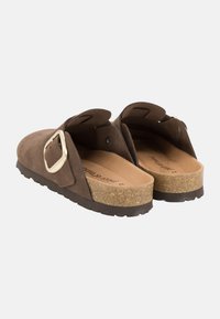 Brown suede backless sandals with a wide strap featuring a gold buckle. Cork footbed with textured rubber outsole for added grip.