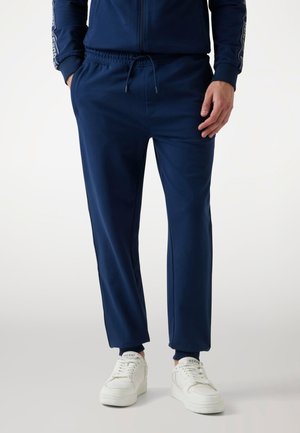 Guess JOGGING - Tracksuit bottoms - dunkelblau