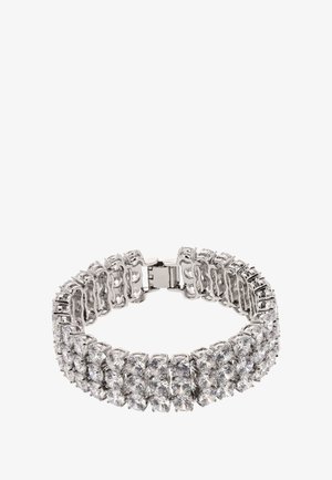 Sølvfarvet armbånd med flere rækker af runde, klare rhinsten. Designet er fleksibelt med en sikker lås.