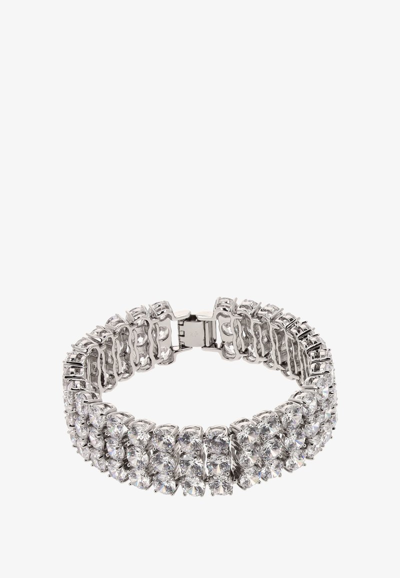 Brăţară de ton argintiu, cu multiple rânduri de strasuri rotunde, clare. Designul este flexibil, având un închizător sigur.