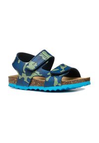 Sandalias camufladas azules y verdes con correas ajustables, plantilla de corcho y suela de goma. Presentan un borde texturizado con un diseño en zigzag.