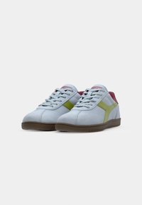Light blue suede sneakers with green and dark red accents, featuring a lace-up design and a textured brown rubber sole.