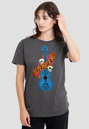 Gray cotton t-shirt featuring colorful graphic of a guitar with skulls, flowers, and text reading "REMEMBER ME." Casual fit and crew neckline.