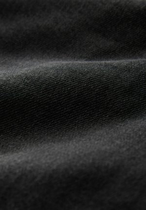 Schwarzer Stoff mit strukturierter Oberfläche, der subtile Wellen und ein weiches, mattes Finish zeigt. Das Material wirkt haltbar und dicht gewebt.