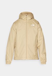 Beige The North Face lightweight waterproof jacket with hood, elastic cuffs, and front zipper closure.