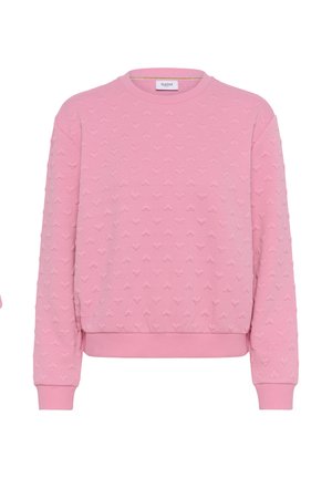 Bluză roz cu guler rotund, cu model texturat în formă de inimă, manșete și talie tricotate, etichetată „Saint” în interiorul gulerului.