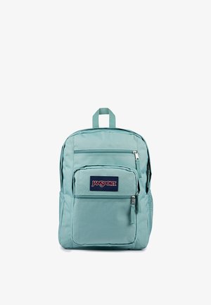Lyseblå Jansport rygsæk med tre lynlåslommer og en netlomme i siden, vist mod en hvid baggrund.