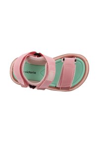 Sandalias rosas con dos correas ajustables, suela de goma y una plantilla en verde menta. Hechas de tejido suave, con un diseño ajustado.