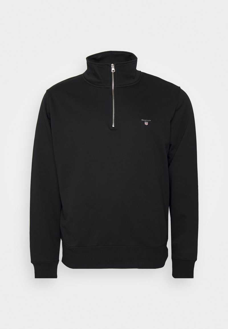 Zwart sweatshirt met rits en opstaande kraag, gemaakt van zachte stof. Heeft ribgebreide manchetten en onderrand, met een klein logo op de borst. Minimalistisch ontwerp.