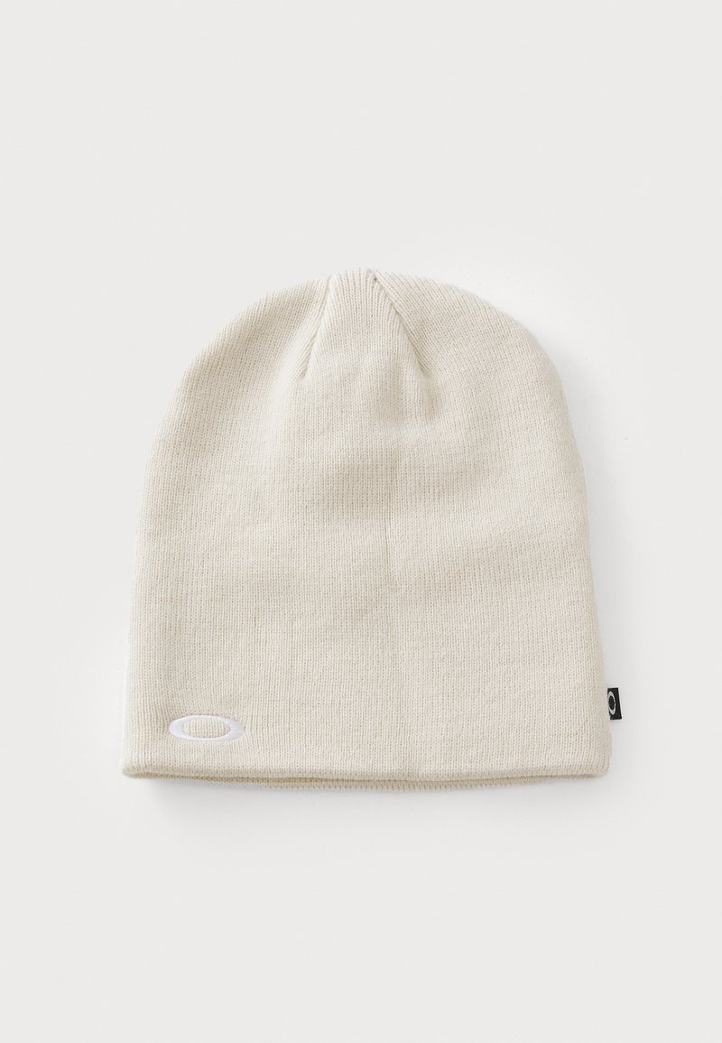 Beige knit beanie with a soft texture and a cuffed design. Features a small logo tag on the side, perfect for casual wear.