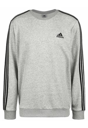 Sudadera Adidas de color gris claro con detalles de tres franjas negras en las mangas y logo de Adidas en la parte superior izquierda del pecho.