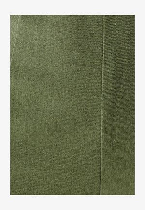 Olive green textured fabric showing a woven pattern, with subtle variations in shade and a clean seam detail on the edge.