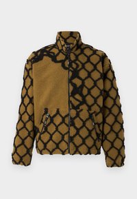 Fleece jacket in brown with a black geometric pattern. Features a high collar, front zip closure, and two side zip pockets.