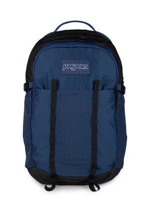 Blauer und schwarzer Jansport-Rucksack mit vorderen Brustgurten, oberem Tragegriff und zwei Reißverschlussfächern vor weißem Hintergrund.