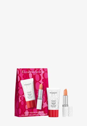 Crème protectrice pour la peau Elizabeth Arden Eight Hour et baume à lèvres couleur pêche avec emballage rouge et blanc et boîte du produit.
