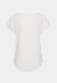 Lys beige t-skjorte, korte ermer, rund halsutringning, glatt tekstur, buet nederkant bak, minimale sømmer, ingen synlige merker eller mønstre.