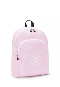 Mochila de tela rosa con un diseño redondeado, dos compartimentos con cremallera, un asa negra en la parte superior y un logo circular en la parte frontal.