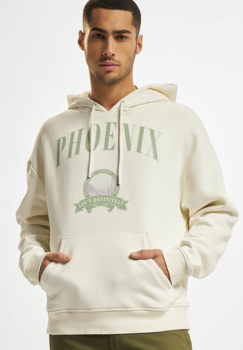 Felpa color crema con cappuccio, tasche frontali e scritte grafiche verdi. Presenta polsini e orlo a coste, realizzata in un morbido tessuto testurizzato.