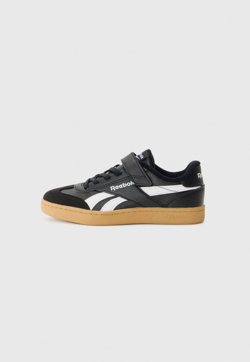 Black and white Reebok sneakers featuring a suede and leather upper, strap closure, and gum rubber outsole. Classic design with logo accents.