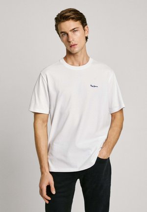 White cotton t-shirt with a round neck, short sleeves, and a navy blue embroidered logo on the chest. Smooth, lightweight fabric.