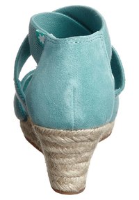 Světle modré semišové sandály s texturovaným espadrilovým podpatkem. Mají nastavitelné popruhy a nízký klínový design pro zvýšené pohodlí.