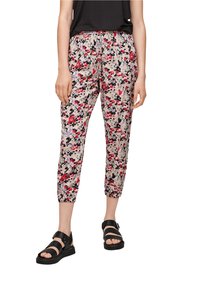 Pantalon à imprimé floral avec un fond beige clair agrémenté d'accents rouges, violets et noirs, taille élastique et longueur chevilles raccourcie.