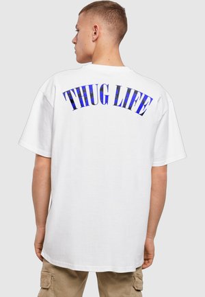 White oversized t-shirt featuring a blue gradient print that reads "THUG LIFE" across the back in bold, arched lettering.