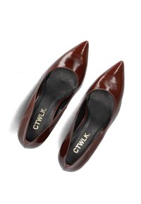 Brown patent leather pointed-toe flats with a smooth finish and cutouts. Interior features black lining with "CTWLK." branding.