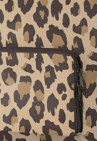 Leopard print bag with a tan and brown color scheme, featuring a textured surface and a black zipper closure in the center.