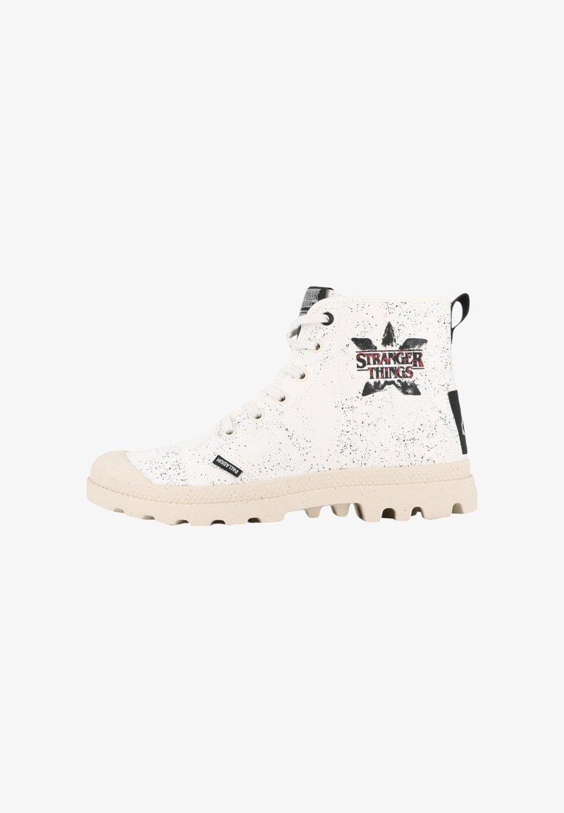 White high-top sneakers with speckled black accents, featuring a textured rubber sole and a "Stranger Things" logo on the side.